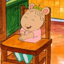 Sitting in her high chair.