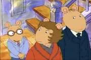 Arthur in a blue suit with a purple necktie