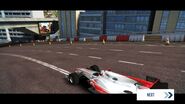 A post-race McLaren MP4-25 with a billboard featuring the splash screen for Asphalt Xtreme in the background.