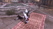 Ezio standing over humiliated Santino