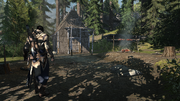 Connor standing by Myriam's cabin