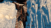 Aveline scaling the frozen waterfall