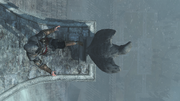 Ezio kicking a statue over the edge of the fortress' roof