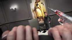 Daniel restraining Berg while holding an injection gun