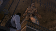 Desmond looking at Altaïr's statue