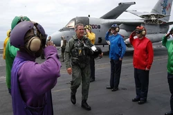 Bush being saluted aboard the 