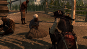 Aveline mentre parla con un gruppo di schiavi.