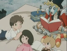 Munk reading to village children