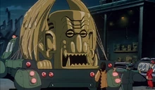 Jake stands in front of his sculpture with a client