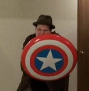 Hiding behind the Captain America Shield.