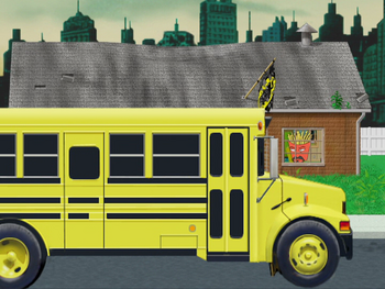 A school bus parked in front of the Aqua Teens' house