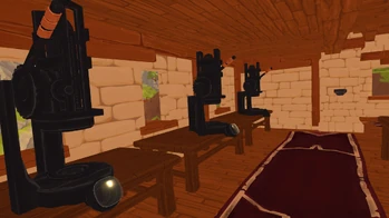 To the left of the coin banks, up the stairs on the second level you will find the Coin Presses.