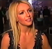 Britney wearing her fembot bra in a behind-the-scenes interview.