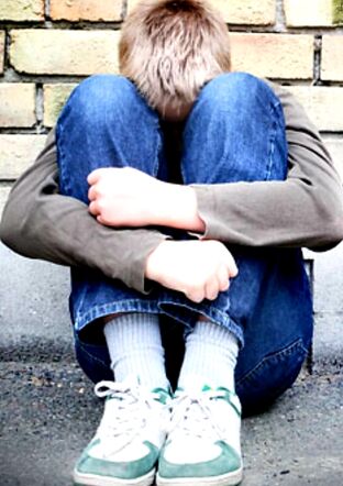 Anxious Autistic teen boy in fetal position .jpg