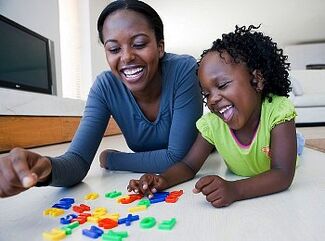 Woman and Child Playing with Letters from blackdoctor