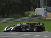 
The No. 31 Lotus T128 at the  showing the damage on its left-hand side and with the open left door