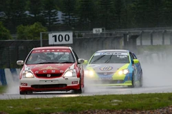  leads Kenneth Look in the rain at ZIC during a Hong Kong Touring Car Championship race.