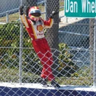 Castroneves climbing the fence to celebrate his win in the 