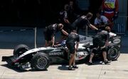 The  mechanics push 's  into the garage during qualifying.