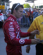 Dan Wheldon signs autographs for fans following Pole Day qualifications at  in 2007.