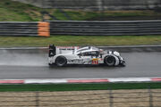 Webber driving his Porsche 919 Hybrid on a sodden track surface at the Shanghai International Circuit in China