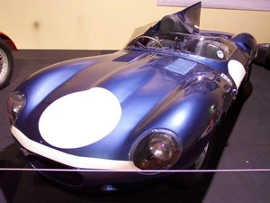 A  in the metallic blue with white nose-band livery of Ecurie Ecosse (1956 Le Mans race).
