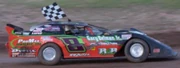  stock car driver celebrates with a chequered flag