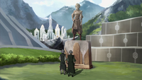 Lin and Su look at a statue of Toph