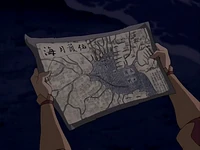 Palartok reading the map of the Patolla Isles.