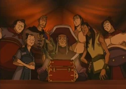 De Piraten staan te glunderen om het kistje met smakeljk goud.