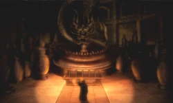 Zuko houd een lamp op in Sozin's Grafkamer en we zien een gouden draak in een kom met ervoor een tafel met vijf kistjes.