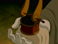 Iroh holding out the headpiece