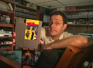 The Nerd shows us the game cartridge.