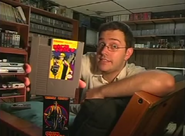 The Nerd holding the Dick Tracy NES cartridge.