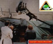 Producer Gordon Carroll, modeller Shirley Denny and director Ridley Scott watch Scammel test a rig used in the final sequence where the Alien is ejected from the shuttle.[2]