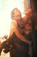 Production still of Ripley carrying Newt, with her weapon slinged.