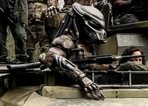 One of the Emissary Predators with a modified M240 slung under its arm.