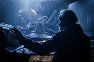 Promotional image of Ridley Scott on the set of the Juggernaut pilot chamber.