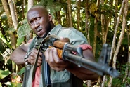 Mombasa with his AKMS in a promotional image for Predators.