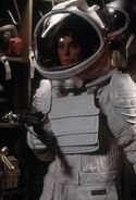 Ripley in a white emergency pressure suit.