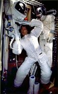 Ripley putting on a white emergency pressure suit.