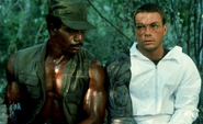 Photo of Jean-Claude Van Damme on set, with Carl Weathers.