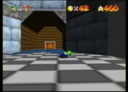 The wooden hall, with a pair of doors in its start, or end, depending of the point of view. The distinct blue carpet is present.