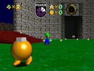 The entrance to Clock Tower beside a Yellow Bob-Omb that uses placeholder dialogue.