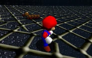 Mario watches as the small, defeated Wiggler slowly walks away.