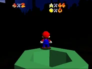 Mario emerges from the pipe.