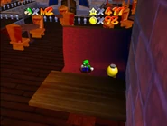 Luigi sitting beside the Bob-omb Buddy.
