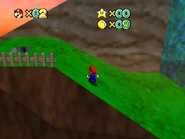 The cliff, separated from the mountain by the waterfall.