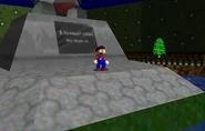 Mario standing next to the monument.