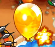 Close-up view of the golden bloon. (Note the camo patterns on it.)